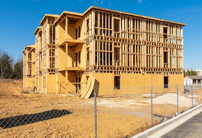 a close-up of temporary chain link fences enclosing a construction site, signaling progress in the project's development in Rancho Santa Fe